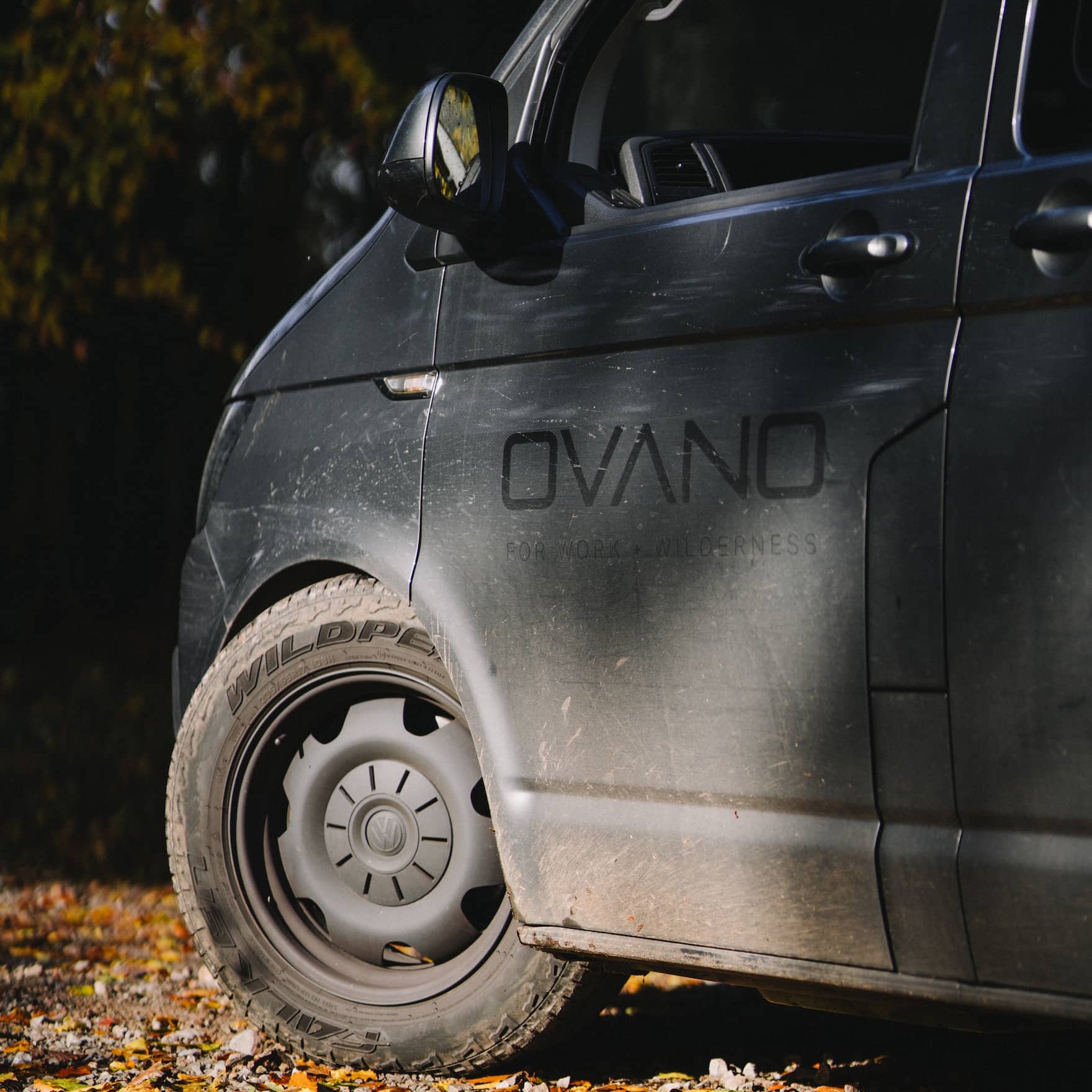 ovano vinyl installed on grey T6 Transporter in wooded area.