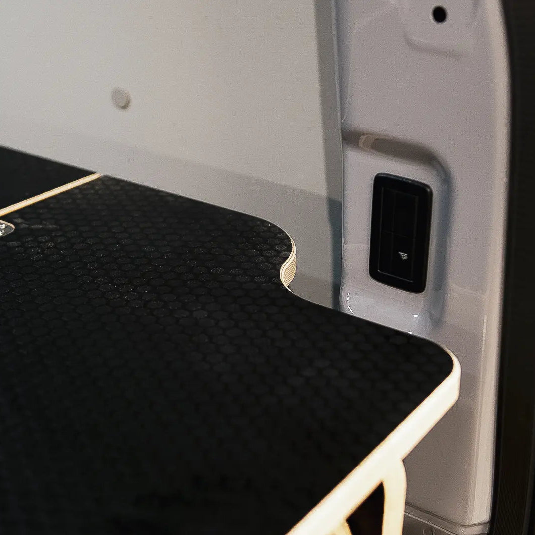 Ovano dual deck rear flap shown with cutout for allow for access to light switch. Grey van.