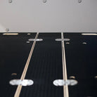 Close-up of top of Ovano dualdeck. Black phenolic plywood with stainless hinges.