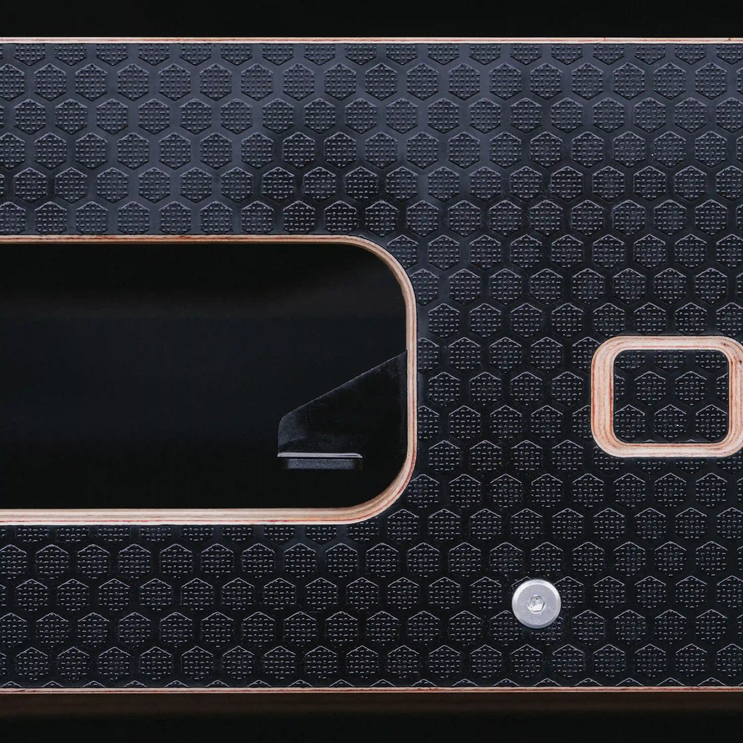 close-up of one touch black drawer lever on a black drawer front.