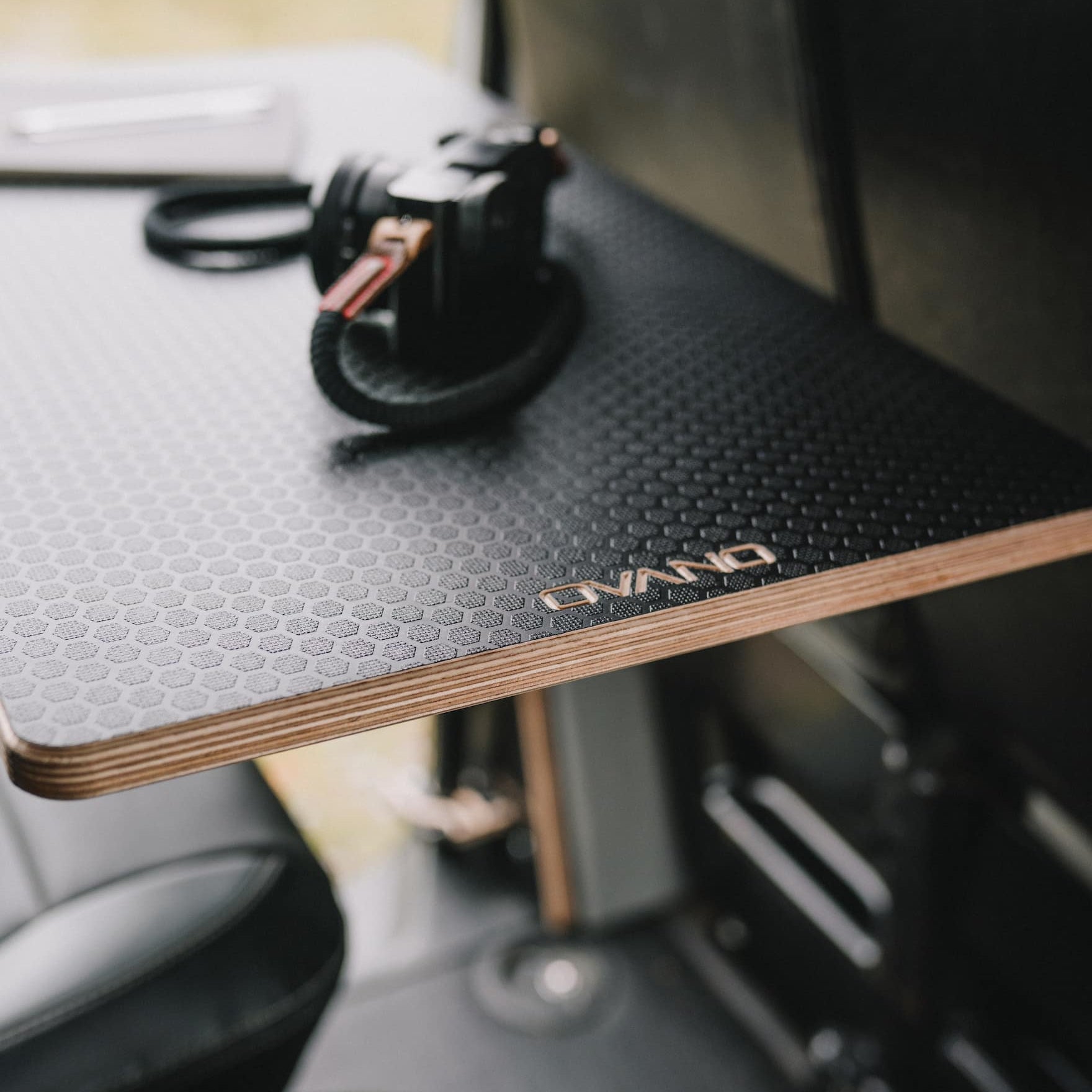 Black Ovano table mounted behind passenger double seat in T5 Transporter