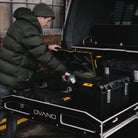 person accessing tools in dewalt tool boxes in a pull out drawer of a van