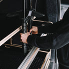 Someone installing an Ovano bike bar in Volkswagen Transporter