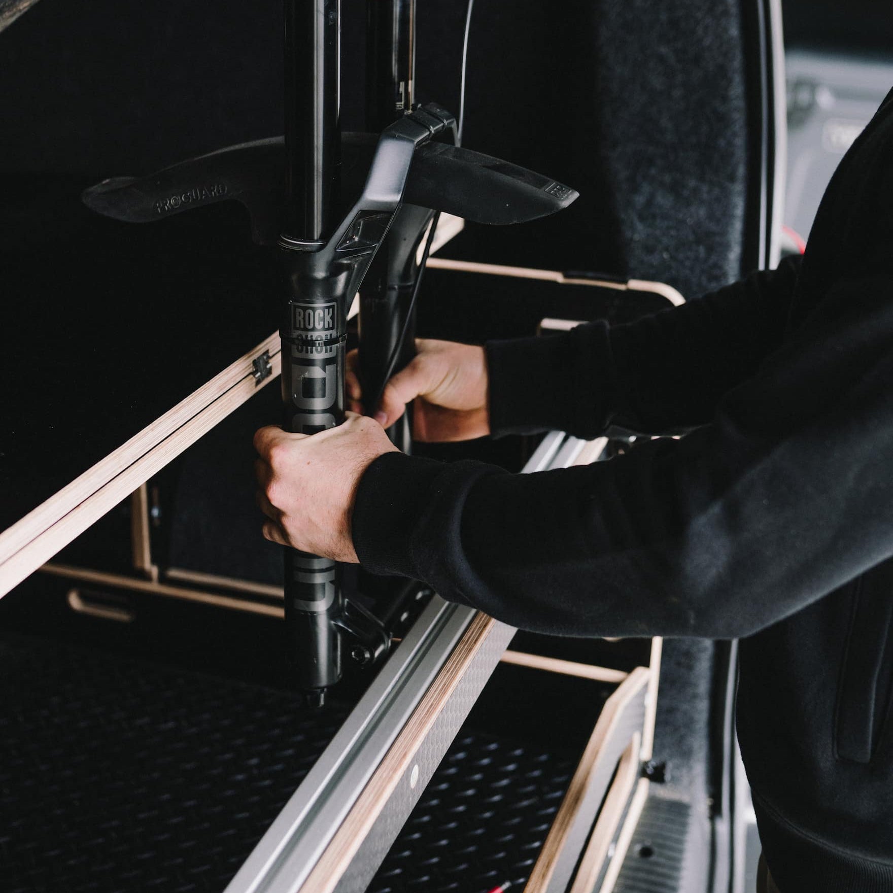 Someone installing an Ovano bike bar in Volkswagen Transporter