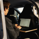 Driverside table installed in T7 kombi. Man using a laptop on table.