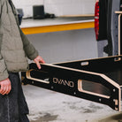 Person using Ovano drawer system in back of Transporter T7 kombi.