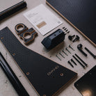 Flat lay of Ovano T5 & T6 table and hardware against a grey floor.