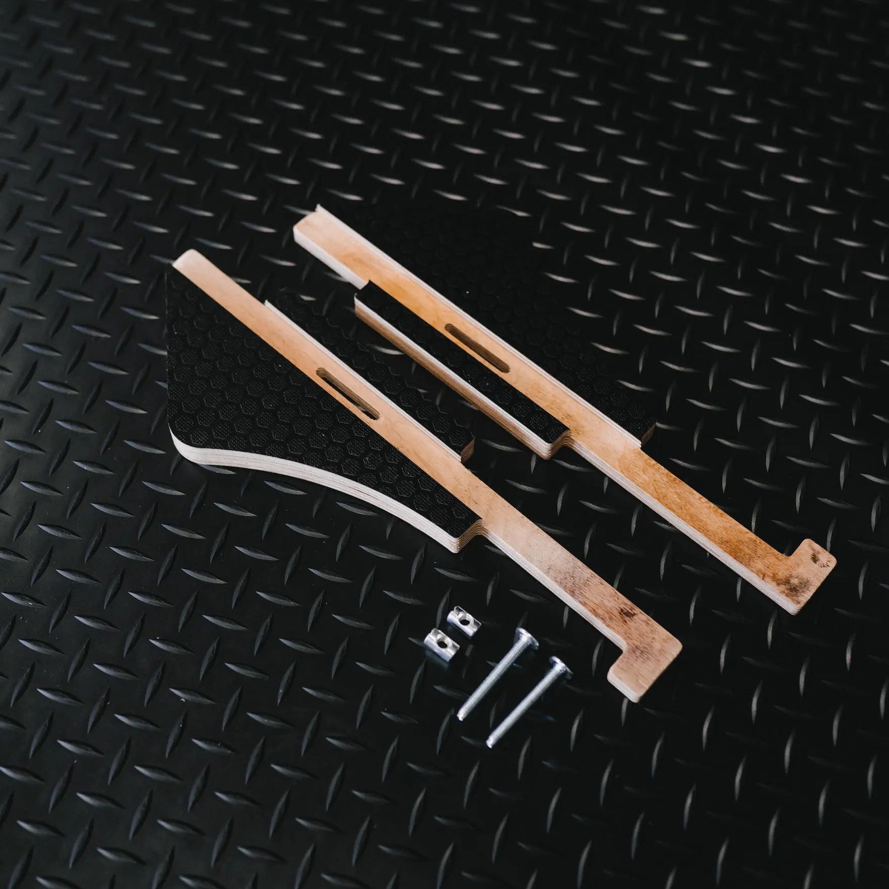 2 x ovano side supports for switch XL, laid out on black rubber mat.