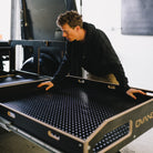Person laying a black ovano rubber mat into a switch xl drawer.