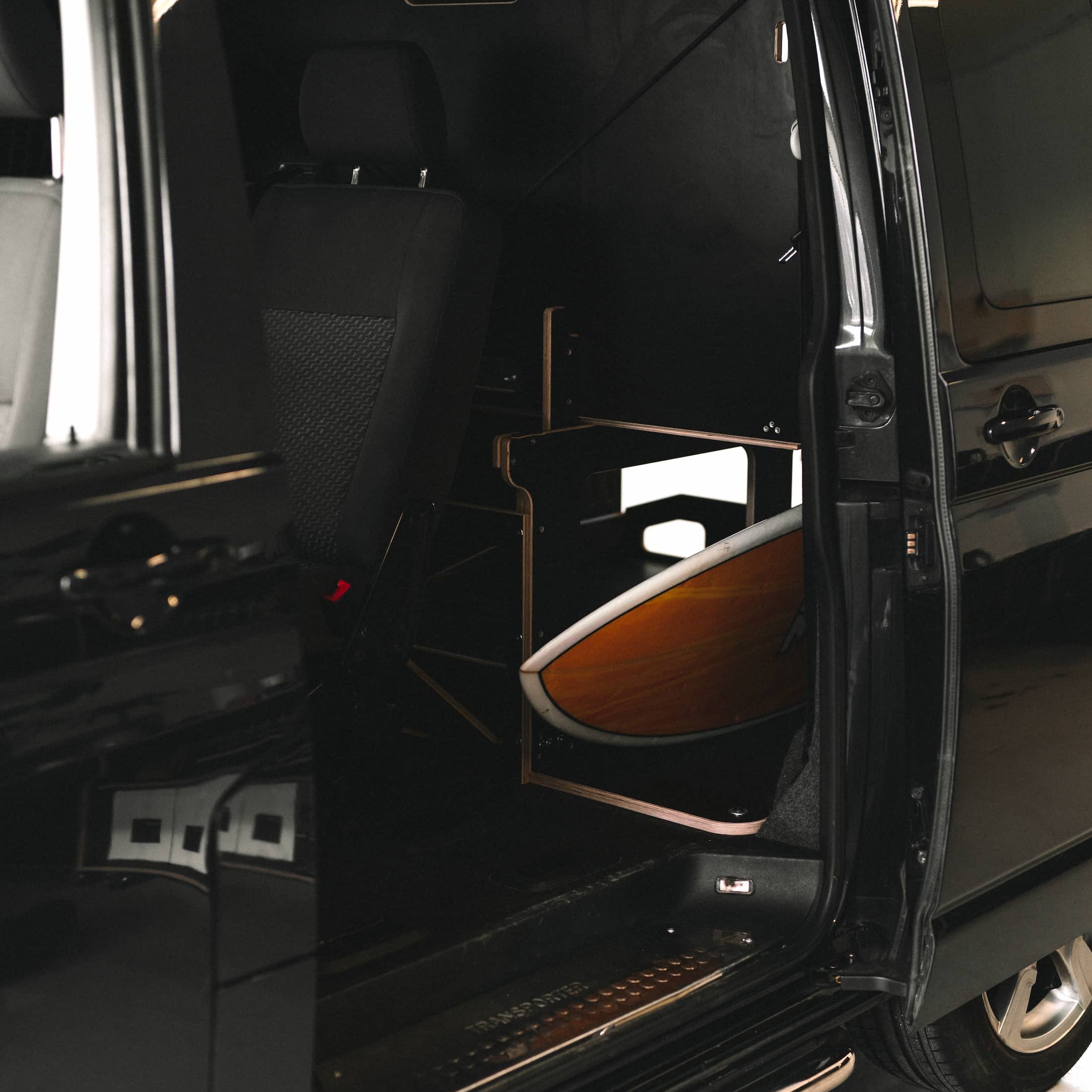 surfboard shown through side door in a T5.1 kombi