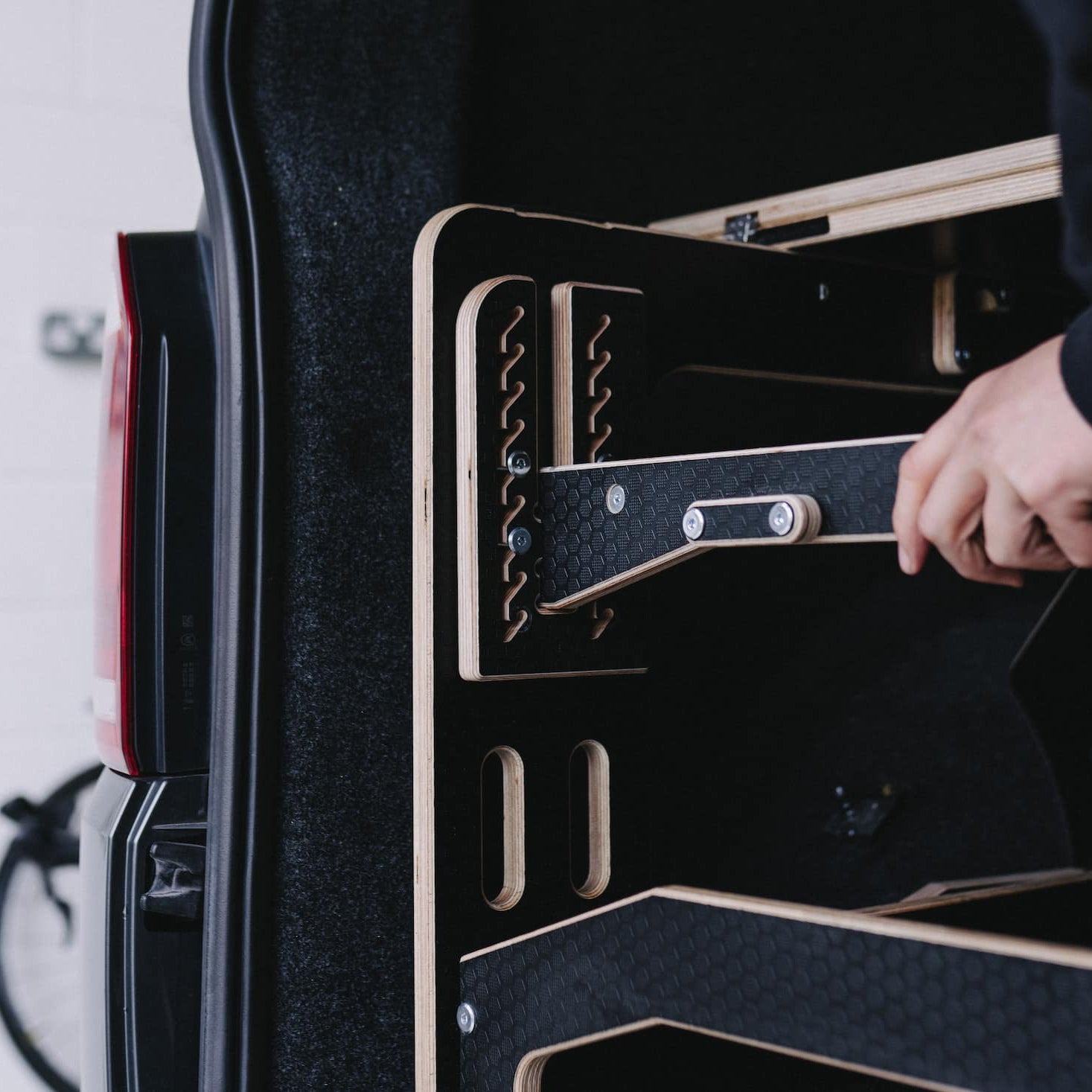 Someone fitting an Ovano bike bar into a van drawer system