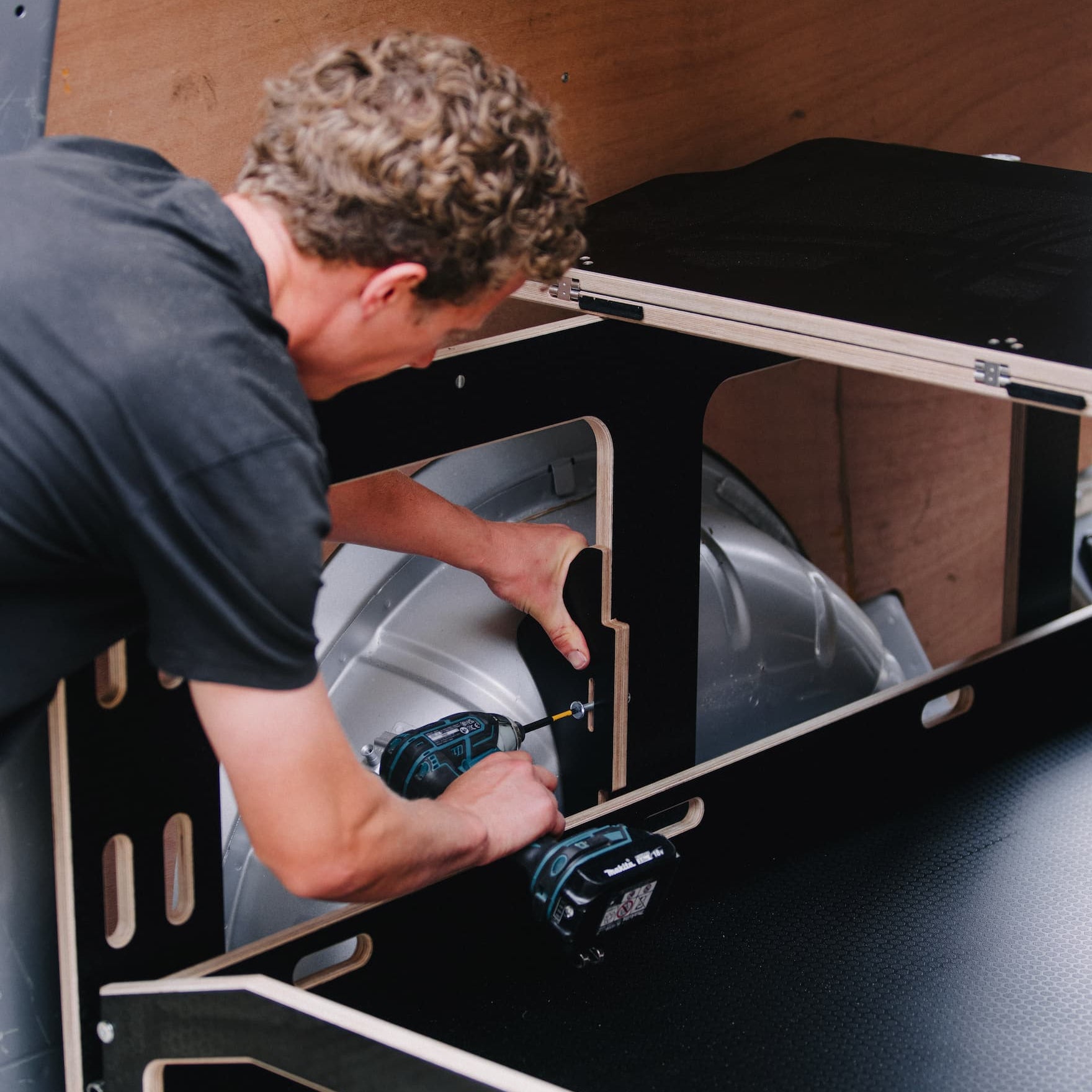 ovano side support being installed on switch xl panel van drawer unit