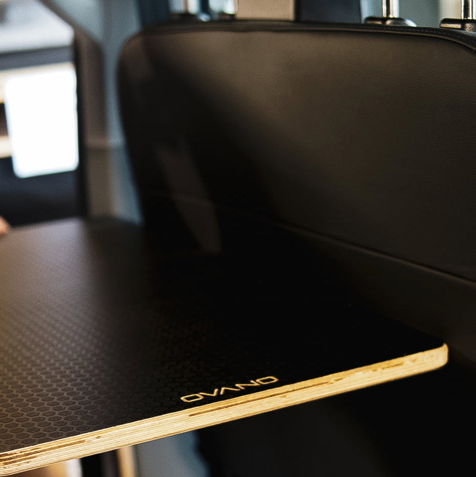 Ovano table installed behind passenger double seat in a VW Transporter.